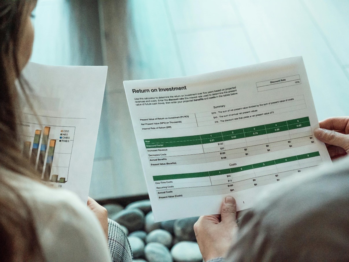 A person holding a positive ROI statement because of custom ERP development