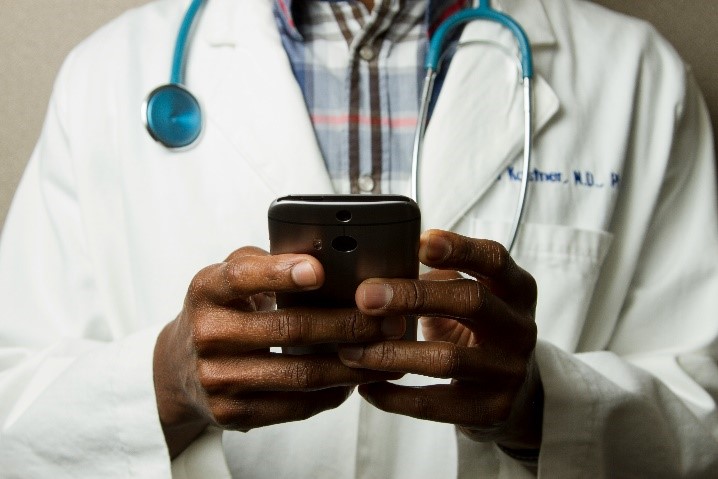 Doctor using mobile technology for digital healthcare solutions in Kuwait